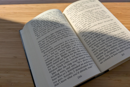 Man with glasses reading a book